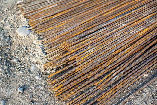 Stack of rusty iron rods or bars. Old metal rusty or steel rod. A lot of rebar is in the warehouse for construction.