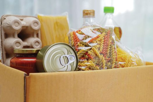 Foodstuffs in donation box for volunteer.