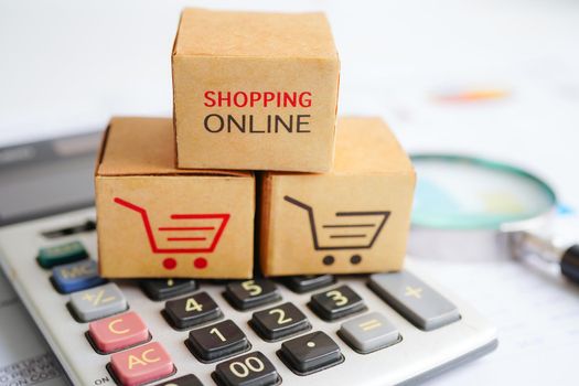 Online shopping, Shopping cart box on calculator, import export, finance commerce.