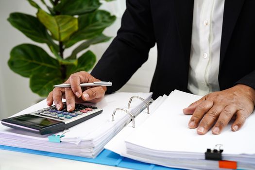 Businessman working and prepare paperwork report data to analysis information in file binder at office.    