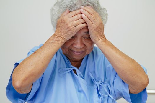 Asian elder senior woman patient headache on bed in hospital, medical concept.