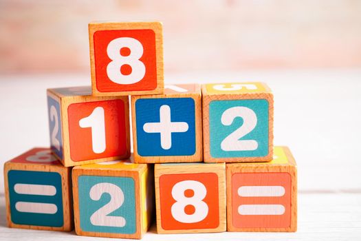 Number wood block cubes for learning Mathematic, education math concept.