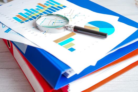 Magnifying glass on charts graphs paper. Financial development, Banking Account, Statistics, Investment Analytic research data economy.