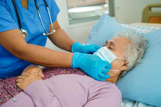 Doctor check Asian elder senior woman patient wearing a mask for protect covid coronavirus.