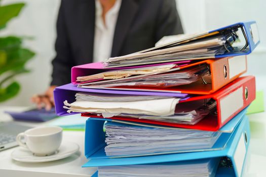 Stack of binder file folder on table in business modern office.
on wooden desk in large modern office 