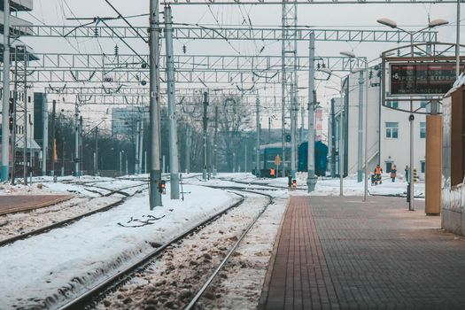 The train arrives at the passenger platform in Minsk on a winter day . High quality photo