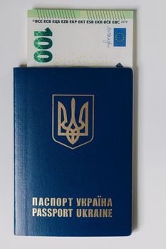 Hundred euro banknote inside Ukrainian passport. Bribe during the war.