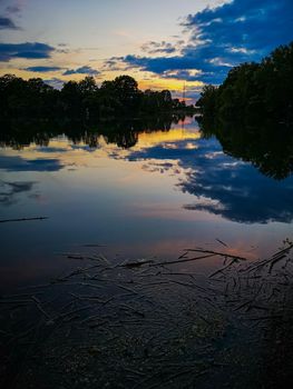 Sunset over beautiful and silent Bajkal lake with reflections in water