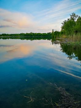 Sunset over beautiful and silent Bajkal lake with reflections in water