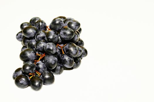 a berry, typically green classified as white, purple, red, or black, growing in clusters on a grapevine, eaten as fruit, and used in making wine.