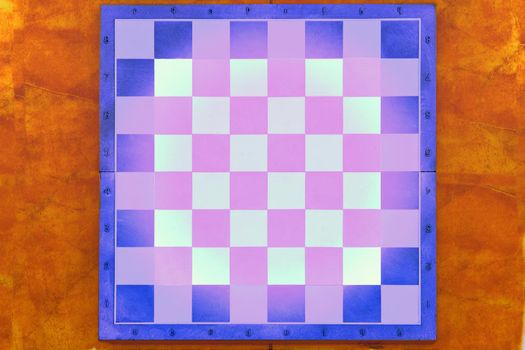 a square board divided into sixty-four alternating dark and light squares, used for playing chess or checkers.Green chessboard on a gray background with space for text.