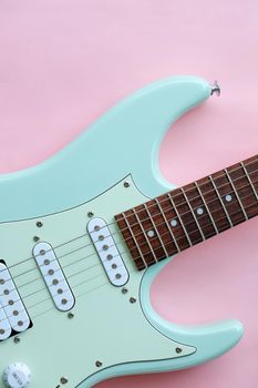 Detail of Mint Green Electric Guitar on a Pink background.