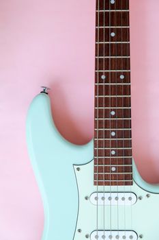 Detail of Mint Green Electric Guitar on a Pink background.