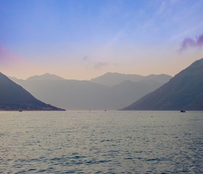 Sunset, beautiful landscape with silhouettes of trees. Travel concept. Montenegro, Kotor Bay. Sunset at Kotor Bay Montenegro. View of the sunset in Boko-Kotor Bay in Montenegro. Silhouettes of mountains. High quality photo