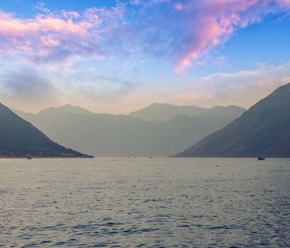 Sunset, beautiful landscape with silhouettes of trees. Travel concept. Montenegro, Kotor Bay. Sunset at Kotor Bay Montenegro. View of the sunset in Boko-Kotor Bay in Montenegro. Silhouettes of mountains. High quality photo