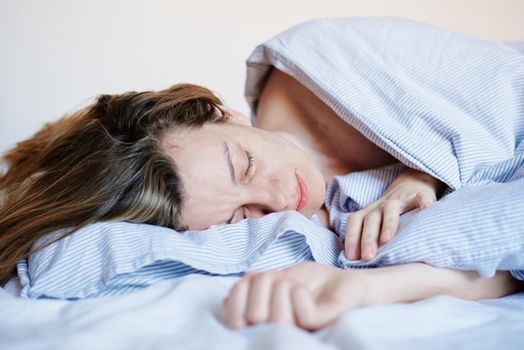 Woman sleeping in the bed at morning