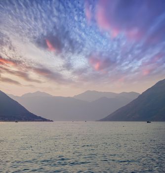 Sunset, beautiful landscape with silhouettes of trees. Travel concept. Montenegro, Kotor Bay. Sunset at Kotor Bay Montenegro. View of the sunset in Boko-Kotor Bay in Montenegro. Silhouettes of mountains. High quality photo