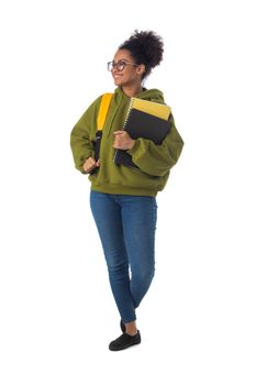 Friendly ethnic black female high school student in eyeglasses with backpack and composition book isolated on white background, full length portrait