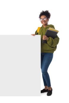 Friendly ethnic black female high school student in eyeglasses with banner and composition book isolated on white background