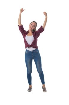 Full-length shot of beautiful girl in shirt and jeans holding arms outstretched up isolated on white background