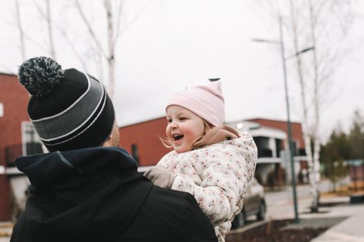 Happy emotional girl with father. Family having fun outdoors. Father and daughter together.