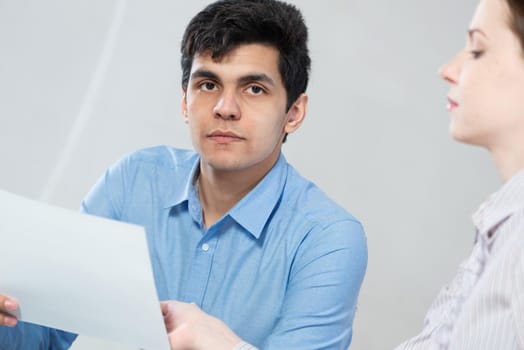 portrait of a young man at a business meeting. concept of team work