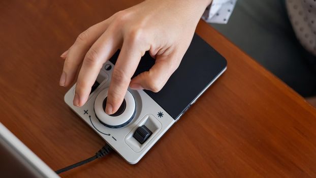 A woman uses a special magnification device for the visually impaired