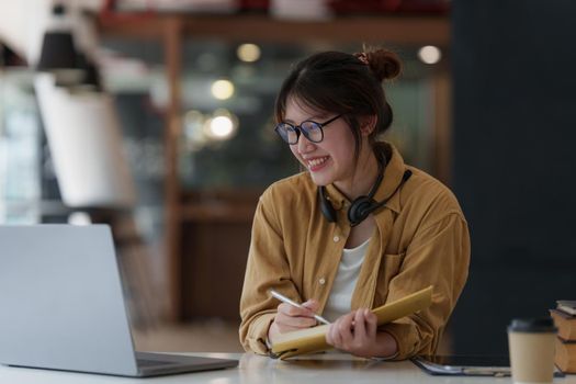 E-learning ,online ,education and internet social distancing protect from COVID-19 viruses concept. Asian woman student video conference e-learning with teacher on digital tablet at home