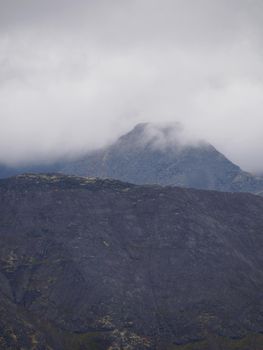 The clouds caught on the tops of the mountains. Low clouds in the mountains. Khibiny, Russia. photo