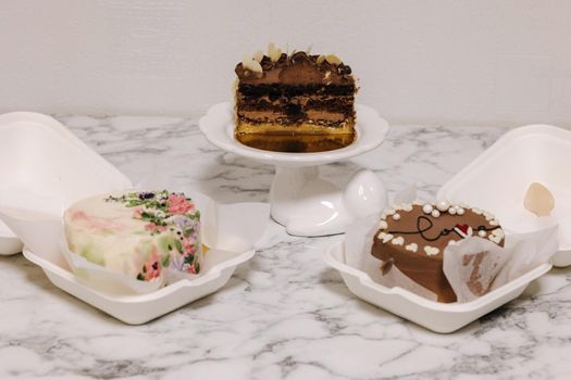 Three different bento cake on white table. Small bento cake for one person as a gift for the holiday.