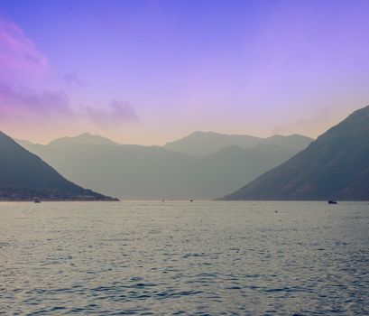 Sunset, beautiful landscape with silhouettes of trees. Travel concept. Montenegro, Kotor Bay. Sunset at Kotor Bay Montenegro. View of the sunset in Boko-Kotor Bay in Montenegro. Silhouettes of mountains. High quality photo