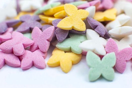 Colorful butterflies, pastel colored sugar confectionery sprinkles. Close-up.