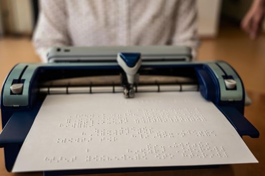 Blind woman using braille typewriter