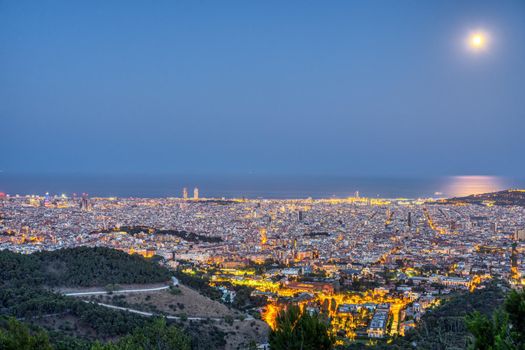 Barcelona at night with a full moon