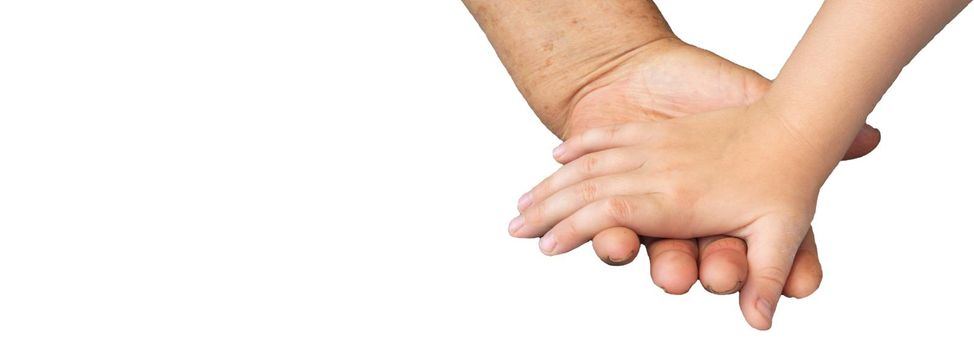 Banner, close-up of the hands of an elderly woman and a small child, isolated on a white background, by clipping. Soft focus image.