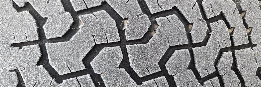 Winter tires on car wheel with frost closeup. Changing winter tires for summer concept