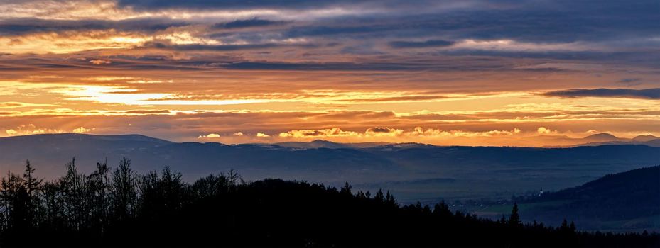 Sunset with dramatic cloudy sky over mountains shape, beautiful nature landscape