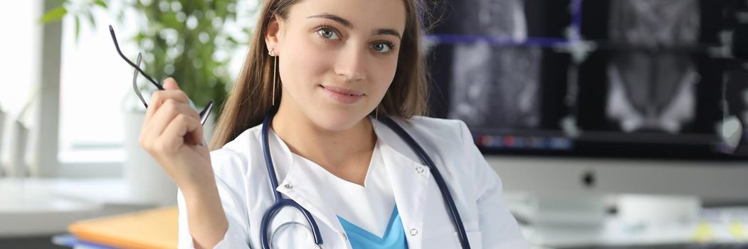 Doctor holding glasses for vision in office of clinic. Health care concept