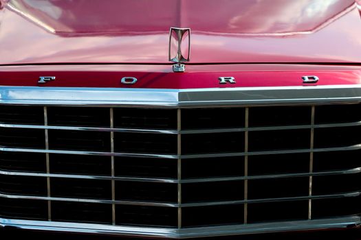 Wroclaw, Poland, August 15, 2021: front view of the grille and hood of an old red Ford