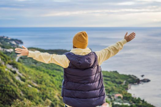 Woman in the mountains of Montenegro in warm clothes. Travel to Montenegro in spring, autumn, winter.