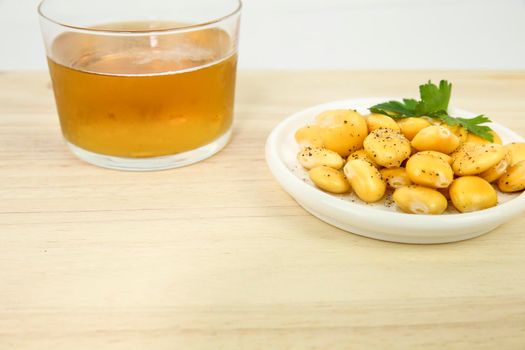 Typical Spanish Tapa of Lupin beans next to cold beer on wooden table