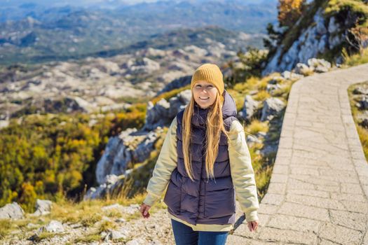 Woman traveller in mountain landscape at national park Lovcen, Montenegro. Travel to Montenegro concept.