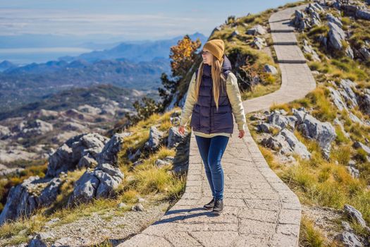 Woman traveller in mountain landscape at national park Lovcen, Montenegro. Travel to Montenegro concept.