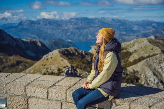 Woman traveller in mountain landscape at national park Lovcen, Montenegro. Travel to Montenegro concept.