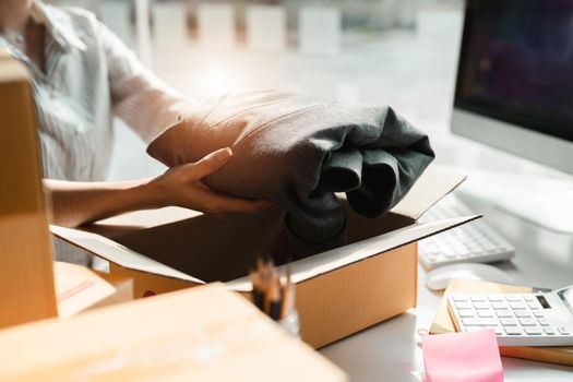 freelance woman working with packaging clothes, startup entrepreneur small business owner at home, Online business seller packaging and delivery concept.