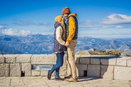 Couple man and woman tourists in mountain landscape at national park Lovcen, Montenegro. Travel to Montenegro concept.