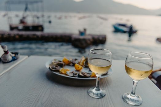 Beautuful seascape with oyster farm and mountains, Adriatic landscape, Montenegro. Oysters farm in sunset, Boka -Kotor Bay, Montenegro