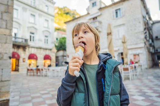 Boy tourist enjoying Colorful street in Old town of Kotor on a sunny day, Montenegro. Travel to Montenegro concept.