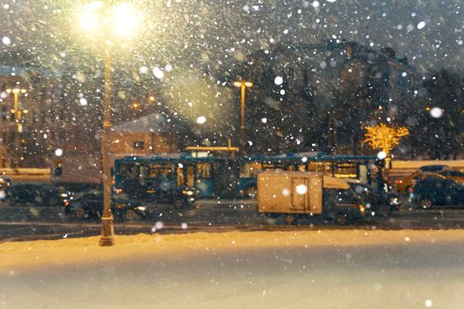 bad weather in Moscow. heavy snowfall and wind, poor visibility. a street lamp illuminates a snow storm. road traffic