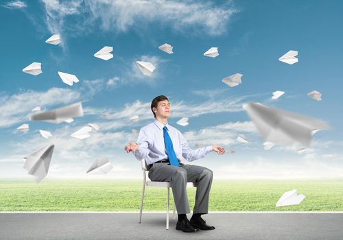 businessman sitting on an office chair, meditation and calmness